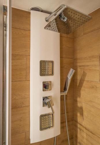 a shower with two lights in a bathroom at Chesa Sarvit in Celerina