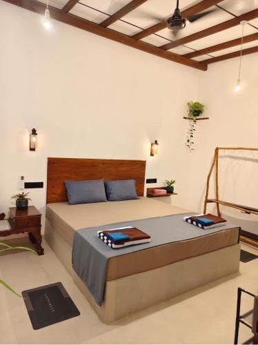 a bedroom with a bed with two towels on it at bluemoonhiriketiya in Dickwella