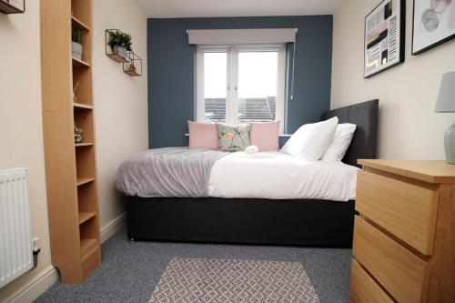 a bedroom with a bed with a window at Alicia's Way by Tŷ SA in Newport