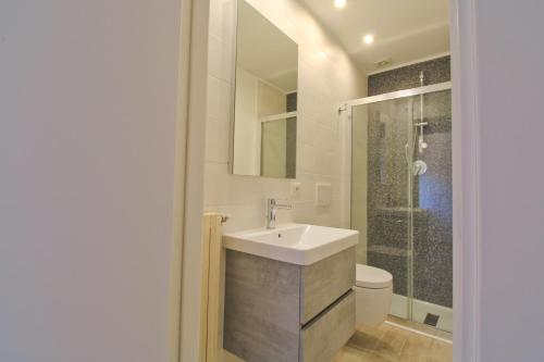a bathroom with a sink and a toilet at Dimora Centro Storico in Sirolo