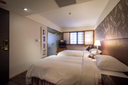 מיטה או מיטות בחדר ב-Delight Hotel