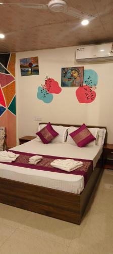 a bedroom with a large bed with pillows on it at Bonsaiyog in Chapora