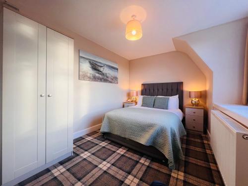 a bedroom with a bed and a dresser in it at Cullen Bay Hotel in Cullen