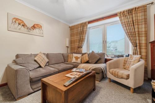 a living room with a couch and a table at Ramsay Lane in Lossiemouth