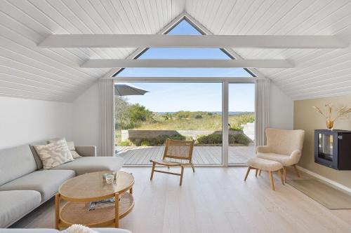 a living room with a couch and a table at Holiday Home Overlooking Ebeltoft Bay in Ebeltoft