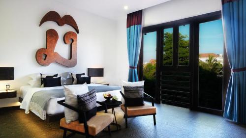 a bedroom with a king sized bed with a large sign on the wall at Golden Temple Villa in Siem Reap