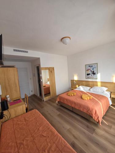 a hotel room with two beds and a mirror at The green house in Malcesine