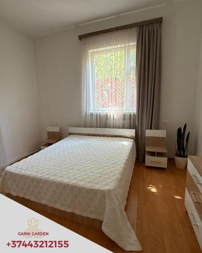 Llit o llits en una habitació de Garni Garden