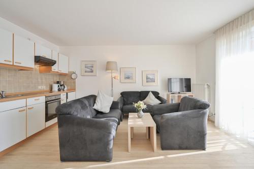 a living room with two couches and a table at FeWo Grytz in Dahme