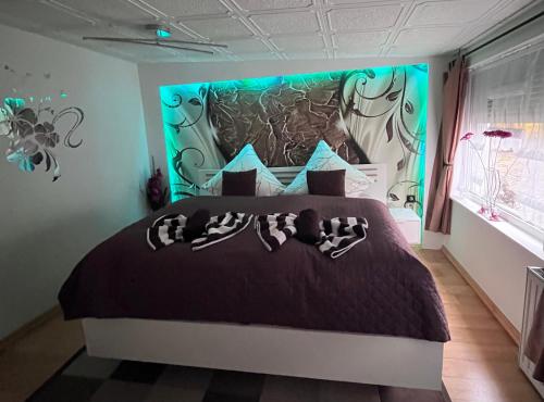 a bedroom with a large bed with a large headboard at Ferienwohnung Heyne in Weinböhla