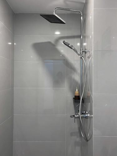 a shower with a glass door in a bathroom at Mom's home in Ninh Binh