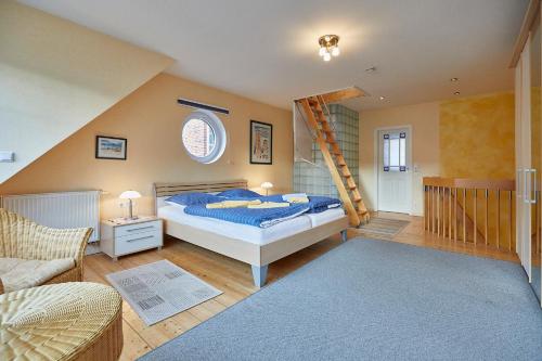 a bedroom with a bed and a ladder at Haus Meyer-Teerling - Ferienhaus in Borkum