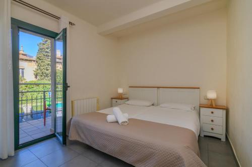 a bedroom with a bed and a balcony at Apartaments Rural Montseny in gualba de Dalt