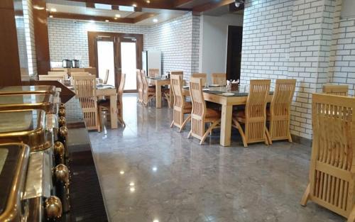 a dining room with wooden tables and chairs at VijayLord's palace Badrinath in Badrinath
