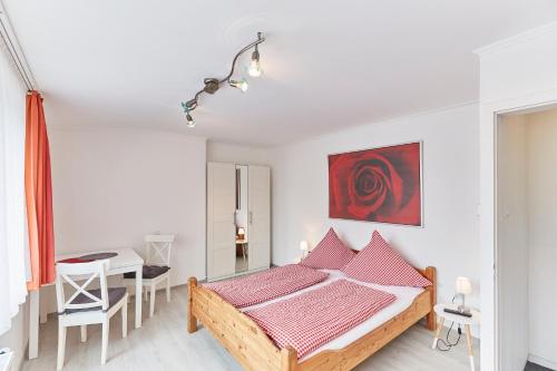 a bedroom with a bed and a table in it at Ferienhaus Lina in Borkum