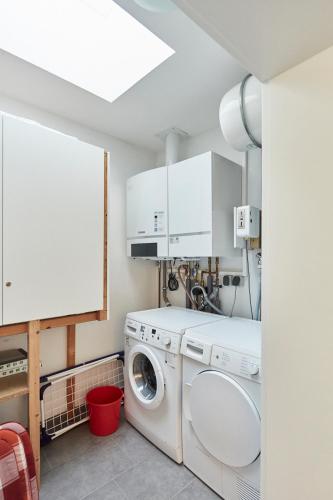 a laundry room with a washer and dryer at Ferienhaus Lina in Borkum