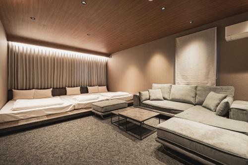 a living room with a couch and a couch and a table at The LOFT INN NAGASAKI in Nagasaki