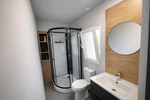 a bathroom with a shower and a toilet and a sink at Sea Mobile Home in Sukošan
