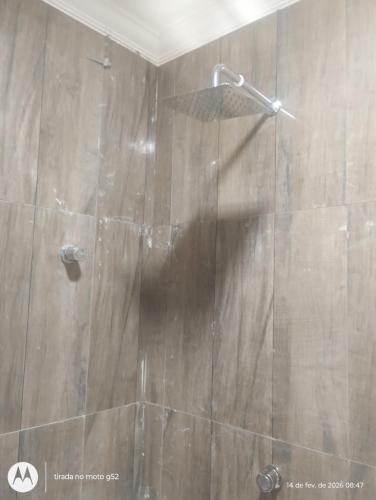 a shower with a glass door in a bathroom at Lajedalu in Aquiraz
