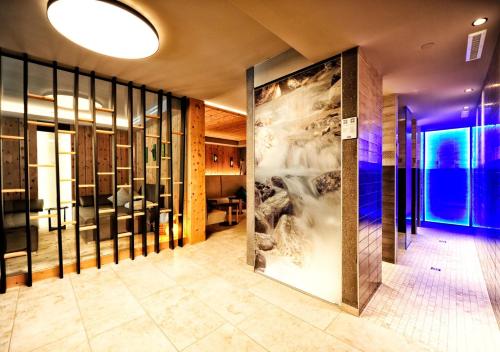 a lobby with a large painting on the wall at Appartement Chesa Monte in Ischgl