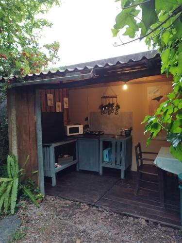 an outdoor kitchen with a table and a microwave at Natura Tiny House Porto in Valongo