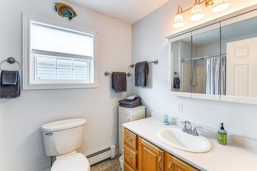 a bathroom with a toilet and a sink and a mirror at Shop, Dine, Unwind! Family Home in Dtwn Bar Harbor in Bar Harbor