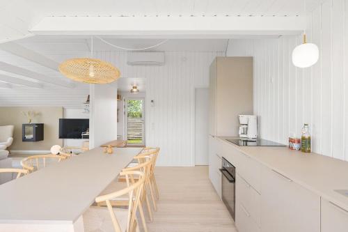 a kitchen and living room with a table and chairs at Holiday Home Overlooking Ebeltoft Bay in Ebeltoft