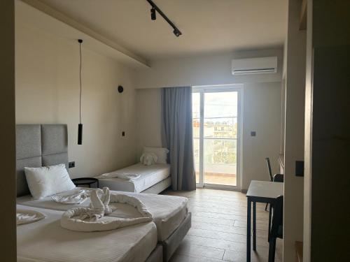 a hotel room with two beds and a balcony at Barbie II in Ialysos