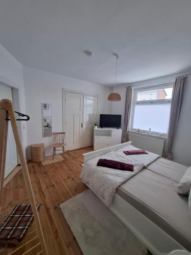 a bedroom with a large bed and a window at Wohnung HoMe No 17 in Parchim