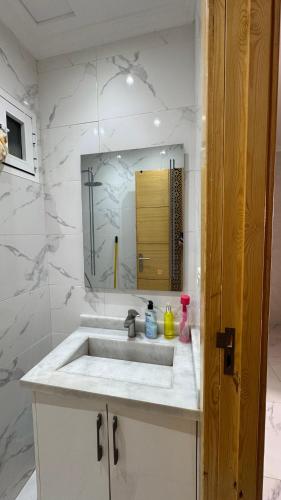 a bathroom with a sink and a mirror at Selouane in Selouane