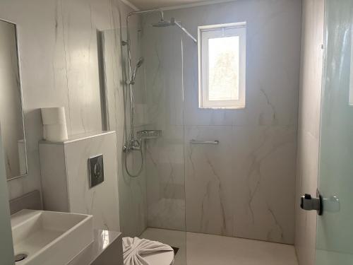 a bathroom with a shower and a toilet and a sink at Barbie II in Ialysos