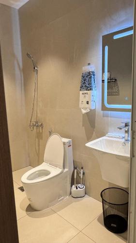 a bathroom with a toilet and a sink at ZA apartment in Al Ahsa