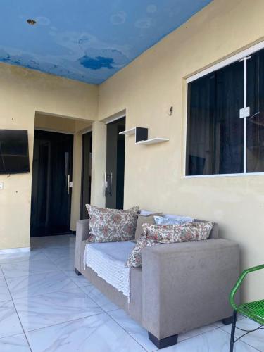 a living room with a couch and a window at Ramos hotel in Barreirinhas