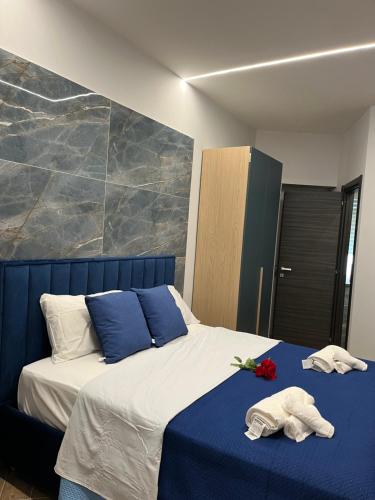 a bedroom with a bed with two towels on it at Domus Anna in Bacoli