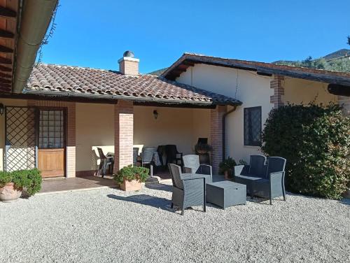 a house with a patio with chairs at La Selvarella in Montecchio