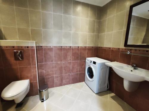 a bathroom with a washing machine and a sink at Santa Marina Breeze - One bedroom apartment in Sozopol