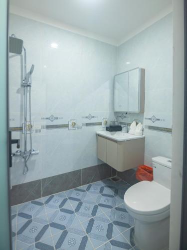 a bathroom with a toilet and a sink and a mirror at Khách sạn Ngọc Anh in Long Hai