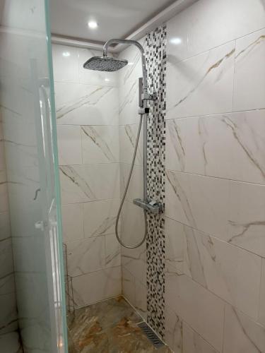 a bathroom with a shower with a glass door at Appartement plein centre marrakech p in Marrakesh
