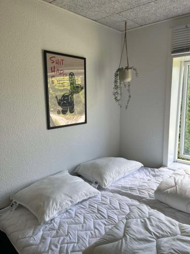 a bedroom with two beds and a picture on the wall at Billund mini hostel room 3 in Billund