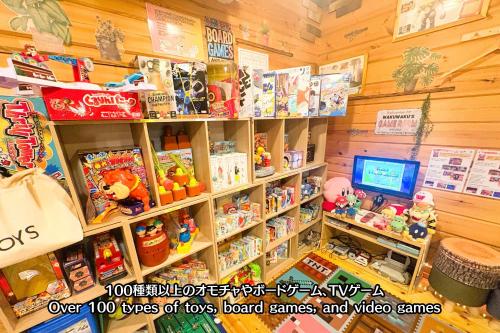 a toy store with toys on shelves and a television at Riverside Oasis WAKUWAKU-BASE in Yabuhara