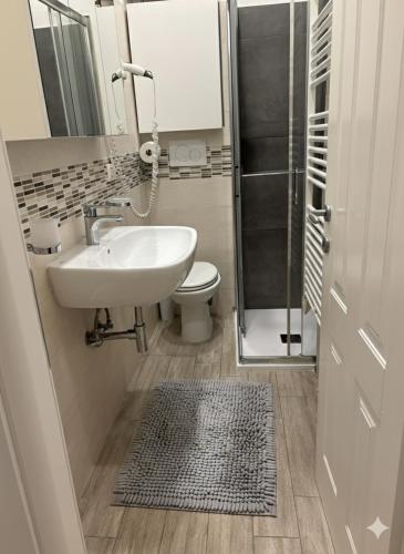 a bathroom with a sink and a toilet and a shower at HOUSE Riccardo, vicino al parco Nelson Mandela in Sestri Levante