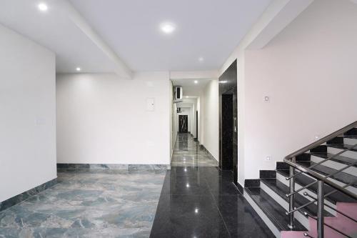 an empty hallway with stairs in a building at FabHotel Golden Suites Near Puri Beach in Puri