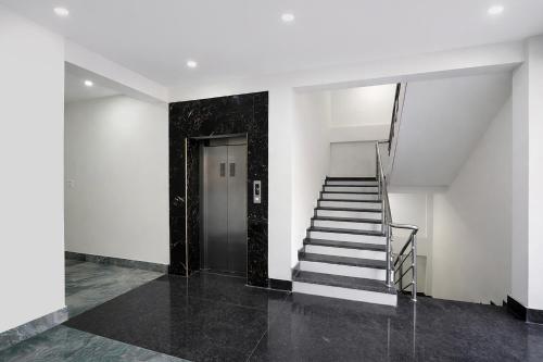 a stairway leading to a door in a white building at FabHotel Golden Suites Near Puri Beach in Puri