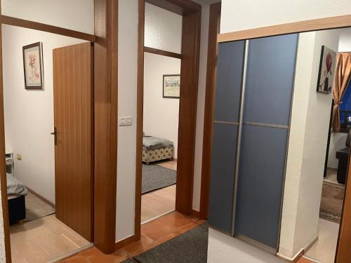 a hallway with a glass door and a bedroom at Grand Panorama Apartment in Fojnica