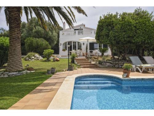 a swimming pool in front of a house at Alaior Villa with Private Pool in Alaior