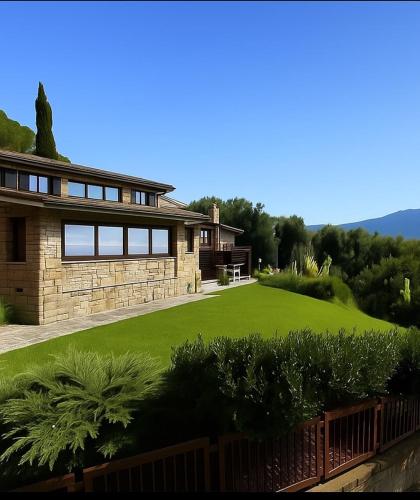 a house with a large lawn in front of it at Panoramic View Village of Villa Luigina Cortona in Castiglion Fiorentino