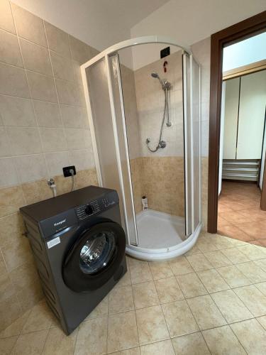 a washing machine in a bathroom with a shower at Ami Affittacamere 3 in Castel San Giovanni