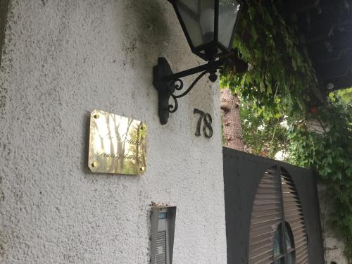 a wall with a light and a sign on it at La Gaura Guest House in Casal Palocco