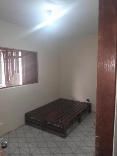 a bedroom with a wooden bed in a room at Casa agrishow in Ribeirão Preto