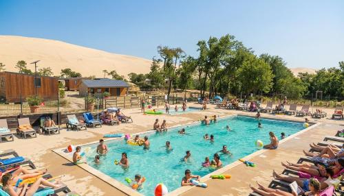 a group of people in a swimming pool in the desert at Camping de la Dune "Les Flots Bleus" in Pyla-sur-Mer